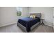 Cozy bedroom with plush carpet, a gray upholstered bed, and a window view of trees at 3878 Amicus Dr, Buford, GA 30519