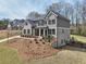 Elegant two-story home with brick and siding, complemented by a beautifully landscaped front yard at 3878 Amicus Dr, Buford, GA 30519