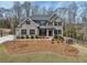Beautiful two-story brick home with black shutters and a well-manicured lawn on a sunny day at 3878 Amicus Dr, Buford, GA 30519