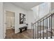 Elegant foyer with hardwood floors, a staircase with black iron railings, bench, and bathroom view at 3878 Amicus Dr, Buford, GA 30519
