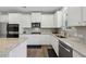 Kitchen features stainless appliances, granite countertops, and white cabinetry at 3878 Amicus Dr, Buford, GA 30519