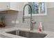 Close up of kitchen sink with stainless steel faucet and granite countertops at 3878 Amicus Dr, Buford, GA 30519