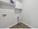 Practical laundry room with overhead cabinets, washer hook-up, dryer outlet, and hard surface flooring at 3878 Amicus Dr, Buford, GA 30519