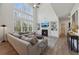 Bright living room features a fireplace, built-in shelving, and floor-to-ceiling windows at 3878 Amicus Dr, Buford, GA 30519