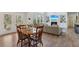Open floor plan with eat-in kitchen table, and living area with fireplace and natural light at 3878 Amicus Dr, Buford, GA 30519
