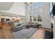 Spacious living room with fireplace, large sectional, and a view into the open concept kitchen at 3878 Amicus Dr, Buford, GA 30519