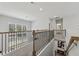 Open upstairs loft area with decorative railing, a staircase, and abundant natural light at 3878 Amicus Dr, Buford, GA 30519
