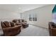 Comfortable upstairs loft area with carpet, neutral colors, and a window view of trees at 3878 Amicus Dr, Buford, GA 30519