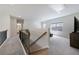 Spacious upstairs loft area with soft carpet, lots of natural light, and a staircase at 3878 Amicus Dr, Buford, GA 30519