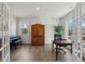 Sunlit home office with a piano, large windows, and warm wood accents at 3878 Amicus Dr, Buford, GA 30519