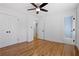 Bright bedroom features hardwood floors, neutral walls, ceiling fan, and access to an ensuite bathroom at 5225 Maple Valley Sw Rd, Mableton, GA 30126
