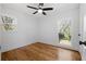Bright bedroom with hardwood floors, ceiling fan, and natural light from two windows at 5225 Maple Valley Sw Rd, Mableton, GA 30126