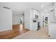 Bright kitchen with white cabinetry and stainless appliances flowing into a living area at 5225 Maple Valley Sw Rd, Mableton, GA 30126