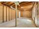 Unfinished basement showing exposed beams and concrete flooring, ready for customization at 3351 Grand Central Dr, Snellville, GA 30078