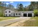 Charming two-story home featuring a long driveway leading to a two car garage at 3351 Grand Central Dr, Snellville, GA 30078
