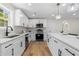 Modern kitchen featuring white cabinets, stainless steel appliances, and hardwood floors at 3351 Grand Central Dr, Snellville, GA 30078
