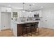 Close-up of the kitchen area with white cabinets, stainless steel appliances, and bright lighting at 3351 Grand Central Dr, Snellville, GA 30078