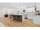 Open kitchen with white cabinets, stainless steel appliances, island seating, and dining area at 3351 Grand Central Dr, Snellville, GA 30078