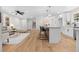 Open concept living area featuring new floors, modern furniture, island seating, and stairway at 3351 Grand Central Dr, Snellville, GA 30078