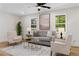 Bright living room with a cozy seating arrangement, large windows, and neutral decor at 3351 Grand Central Dr, Snellville, GA 30078