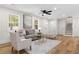 Bright living room with a cozy seating arrangement, stairs, and neutral decor at 3351 Grand Central Dr, Snellville, GA 30078