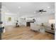 Open-concept living area featuring new floors, modern furniture, and a dining area at 3351 Grand Central Dr, Snellville, GA 30078