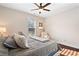 Neutral bedroom features a ceiling fan, a large window and wood flooring at 4121 N Swann St, Covington, GA 30014