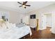Bright bedroom with dark hardwood floors, a ceiling fan, and two windows, creating a peaceful atmosphere at 4121 N Swann St, Covington, GA 30014