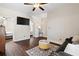 Cozy bonus room features dark wood floors, ceiling fan and neutral paint colors at 4121 N Swann St, Covington, GA 30014