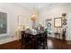 Bright dining room featuring a modern chandelier, hardwood floors, and neutral wall paint at 4121 N Swann St, Covington, GA 30014
