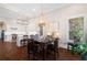 Dining room with hardwood floors, modern lighting fixture and an open view of the kitchen at 4121 N Swann St, Covington, GA 30014