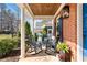 Inviting front porch features rocking chairs, wood ceiling, and well-manicured landscaping at 4121 N Swann St, Covington, GA 30014