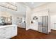Open-concept kitchen with stainless steel refrigerator and seamless flow into the living spaces at 4121 N Swann St, Covington, GA 30014