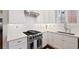 Modern kitchen with stainless steel oven, white cabinets, subway tile backsplash, and sink at 4121 N Swann St, Covington, GA 30014