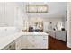 Open kitchen layout with white cabinets, quartz countertops, flowing into the dining area at 4121 N Swann St, Covington, GA 30014