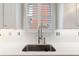 Modern kitchen sink setup featuring white subway tiles, quartz countertops, and modern faucet at 4121 N Swann St, Covington, GA 30014