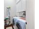Well-equipped laundry room with ample storage cabinets and modern washer and dryer units at 4121 N Swann St, Covington, GA 30014