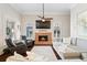 Comfortable living room with a brick fireplace, neutral paint, and hardwood floors at 4121 N Swann St, Covington, GA 30014