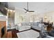 Open-concept living room with a cozy fireplace, a gray sofa, and views of the dining area at 4121 N Swann St, Covington, GA 30014