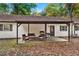 Backyard patio area with outdoor furniture, creating a relaxing space for gatherings at 5785 Woodruff Rd, Chattahoochee Hills, GA 30213