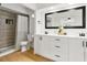 Bathroom featuring dual sinks, modern vanity and tiled walk-in shower at 5785 Woodruff Rd, Chattahoochee Hills, GA 30213