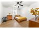 Bright bedroom with wooden floors, ceiling fan and minimalist decor at 5785 Woodruff Rd, Chattahoochee Hills, GA 30213