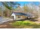 Single-story home with an attached garage and a covered patio area, set on a lush green lawn at 5785 Woodruff Rd, Chattahoochee Hills, GA 30213