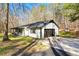 Charming single-story home with an attached garage, driveway, and a well-maintained lawn surrounded by trees at 5785 Woodruff Rd, Chattahoochee Hills, GA 30213