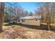 Single-story home with an attached garage and a covered patio area, set on a lush green lawn at 5785 Woodruff Rd, Chattahoochee Hills, GA 30213
