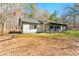 Charming single-story home with a cozy front porch and a well-maintained yard surrounded by mature trees at 5785 Woodruff Rd, Chattahoochee Hills, GA 30213