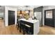 Bright, open kitchen with butcher block island, stainless steel appliances and barstool seating at 5785 Woodruff Rd, Chattahoochee Hills, GA 30213