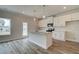 Eat in kitchen features a center island with granite counters, white cabinets, and stainless appliances at 704 Bristol Dr, Loganville, GA 30052