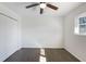 Bright bedroom with dark wood floors, ceiling fan, window, and closet at 1275 Calhoun Ave, Atlanta, GA 30344