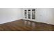 Bedroom featuring hardwood floors and glass patio doors to outdoor deck at 1275 Calhoun Ave, Atlanta, GA 30344